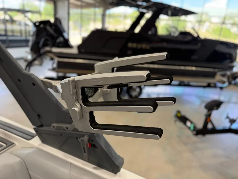Slide: The Image of A boat with a modern wakeboard rack in a showroom. - 24
