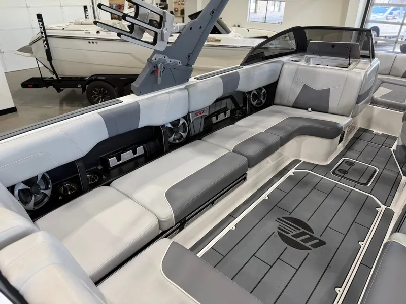 Slide: The Image of The image shows the interior of a 2021 Malibu Wakesetter 24 MXZ with gray and white seating. - 11