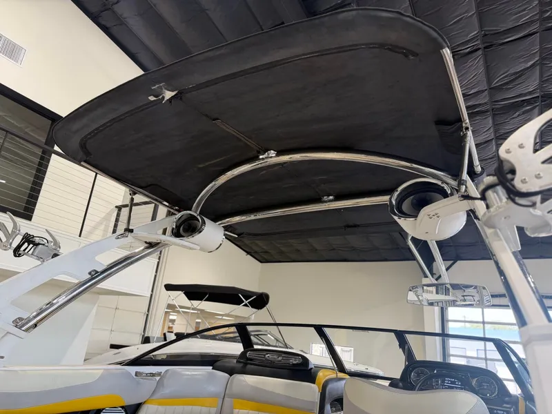 Slide: The Image of The image shows the interior of a Malibu Wakesetter 24 MXZ with a black bimini top. - 9