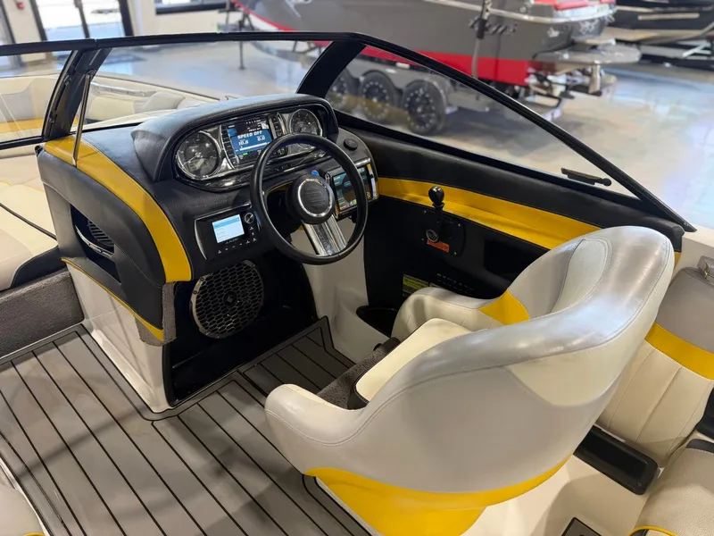 Slide: The Image of The image shows the cockpit of a 2014 Malibu Wakesetter 24 MXZ with yellow accents. - 15