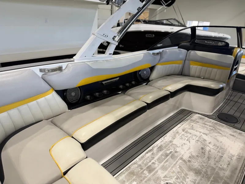 Slide: The Image of The image shows the interior of a 2014 Malibu Wakesetter 24 MXZ with gray and yellow seating. - 12