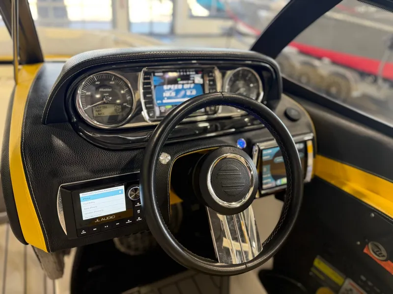 Slide: The Image of The image shows the dashboard of a 2014 Malibu Wakesetter 24 MXZ with modern instruments. - 16