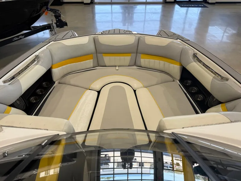 Slide: The Image of The image shows the bow area of a 2014 Malibu Wakesetter 24 MXZ with cushioned seating. - 23