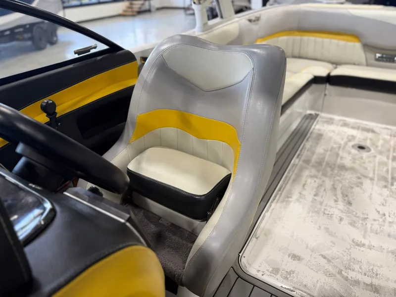 Slide: The Image of The image shows the interior of a 2014 Malibu Wakesetter 24 MXZ with yellow and gray seating. - 26