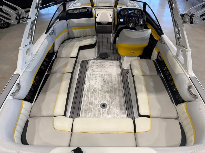 Slide: The Image of The image shows the interior of a 2014 Malibu Wakesetter 24 MXZ. It features white and yellow upholstery. - 11
