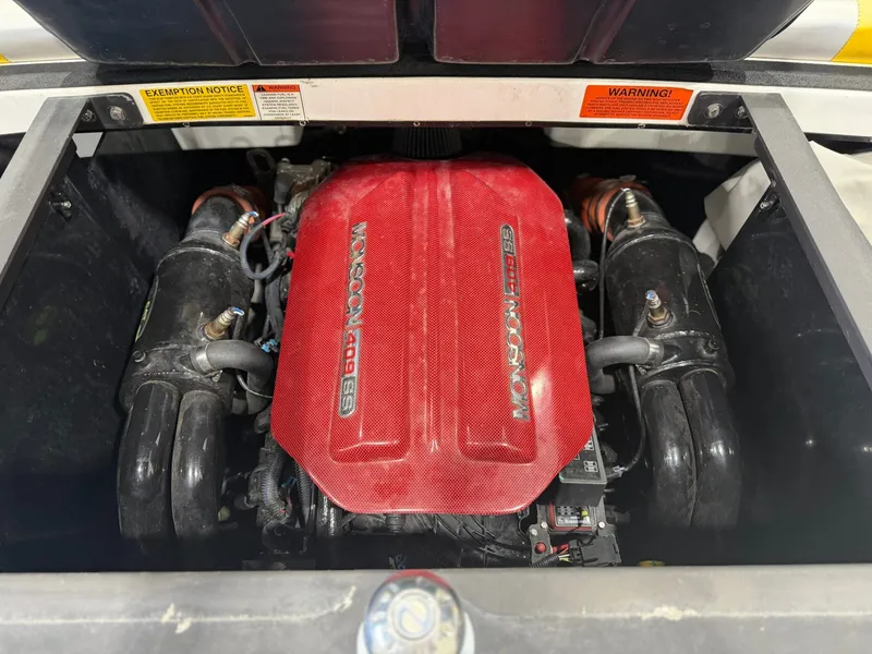 Slide: The Image of The engine compartment of a 2014 Malibu Wakesetter 24 MXZ features a powerful engine with a red cover. - 27