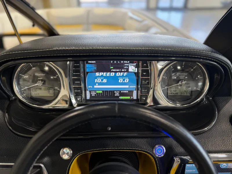 Slide: The Image of Dashboard of a 2014 Malibu Wakesetter 24 MXZ with speedometer and digital displays. - 19