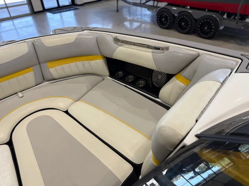 Slide: The Image of The image shows the interior of a 2014 Malibu Wakesetter 24 MXZ with gray and yellow seating. - 25