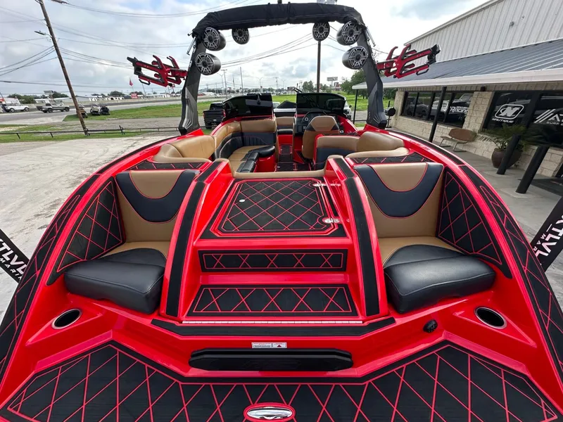 Slide: The Image of The image shows a modern 2023 MB SPORTS B52 boat with striking red and black interior. - 11