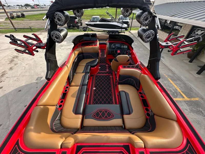 Slide: The Image of The image shows the interior of a 2023 MB SPORTS B52 boat with luxurious seating and speakers. - 12