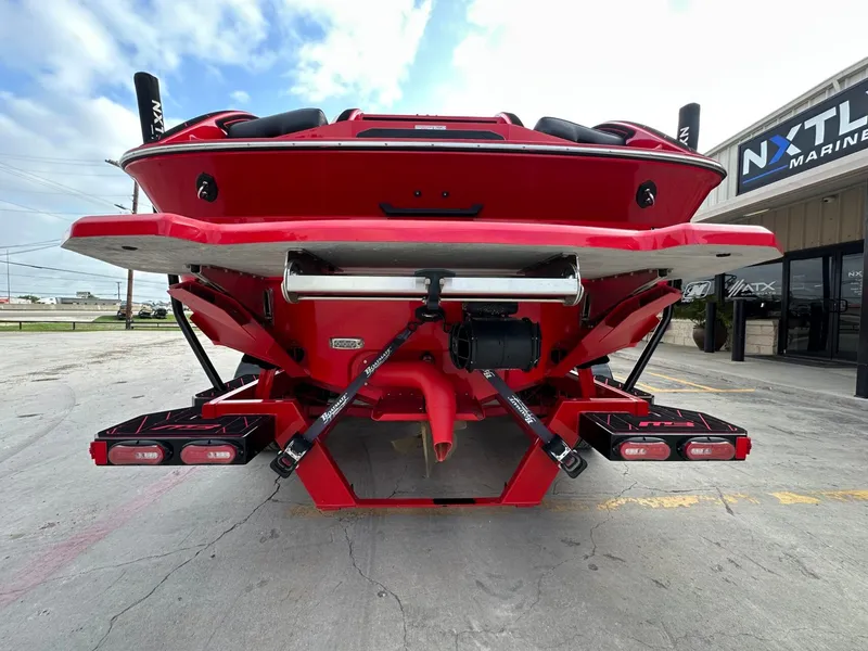 Slide: The Image of The image shows the rear of a red 2023 MB SPORTS B52 boat with dual exhaust pipes. - 5
