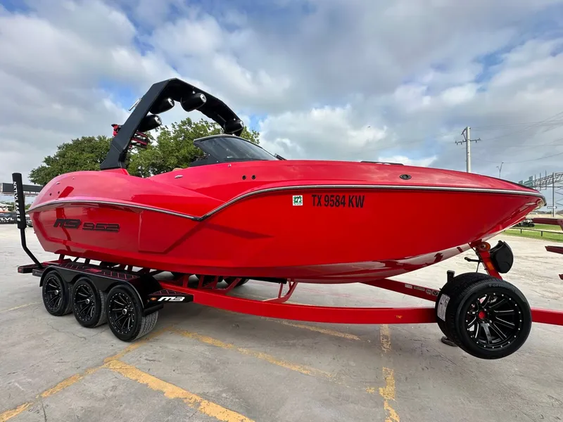 Slide: The Image of A red 2023 MB SPORTS B52 boat on a trailer, ready for transport. - 8