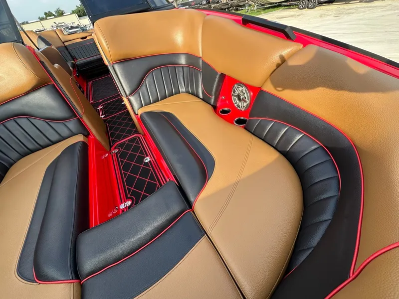 Slide: The Image of The image shows the luxurious seating of a 2023 MB SPORTS B52 boat with brown and black leather. - 27