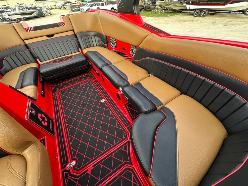 Slide: The Image of The image shows the luxurious interior of a 2023 MB SPORTS B52 boat with red and black accents. - 31