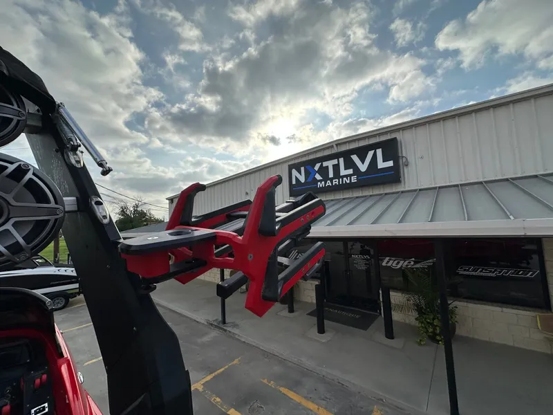 Slide: The Image of An MB SPORTS B52 boat in front of a building with the sign "NXT LVL Marine." - 33