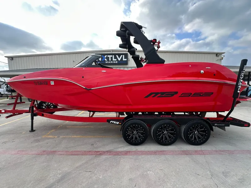 Slide: The Image of 2023 MB SPORTS B52 in bright red with a black tower, on a matching trailer. - 2