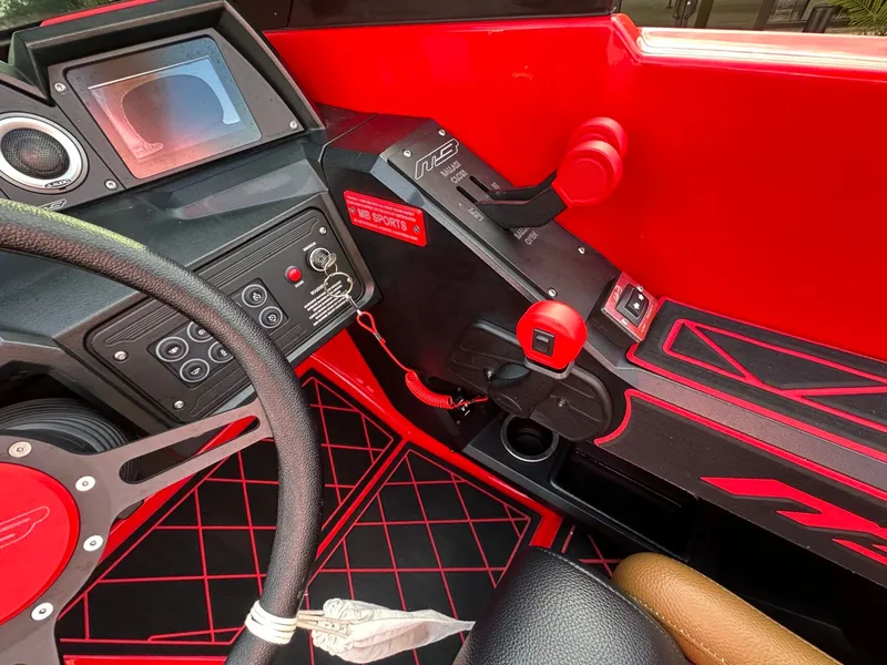 Slide: The Image of The cockpit of a 2023 MB SPORTS B52 with red accents and modern controls. - 36