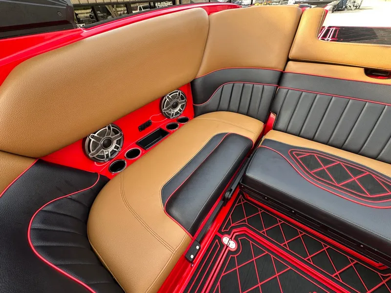 Slide: The Image of The image shows the luxurious interior of a 2023 MB SPORTS B52 boat with sleek seating and speakers. - 13
