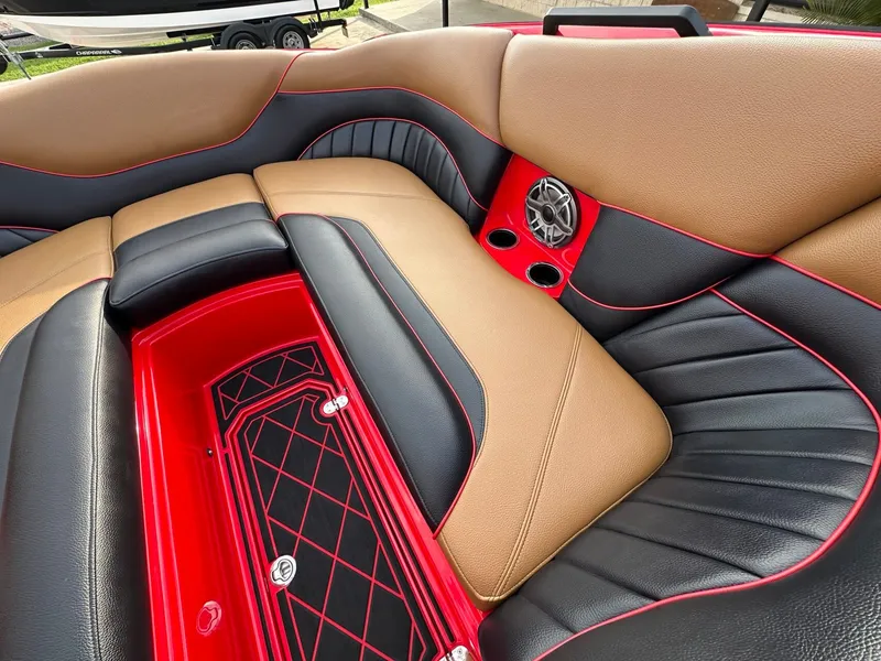 Slide: The Image of The image shows the luxurious interior of a 2023 MB SPORTS B52 boat with red accents. - 24