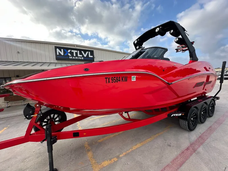 Slide: The Image of A red 2023 MB SPORTS B52 boat on a trailer in front of a building. - 10