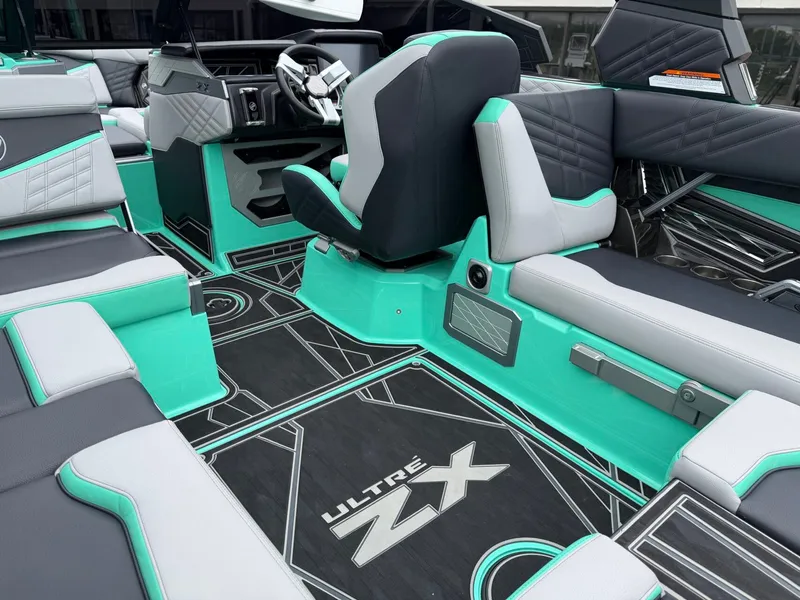 Slide: The Image of Interior of a 2025 Tigé Ultré 23ZX with turquoise and gray upholstery. - 12
