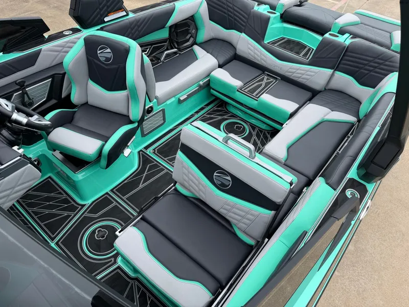 Slide: The Image of The interior of a 2025 Tigé Ultré 23ZX features stylish seating in turquoise, gray, and black. - 20