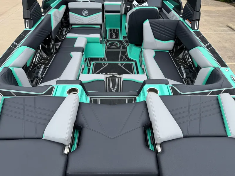 Slide: The Image of The image shows the interior of a 2025 Tigé Ultré 23ZX boat with modern seating. - 7
