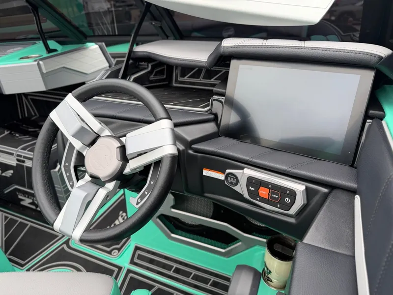 Slide: The Image of The image shows the cockpit of a 2025 Tigé Ultré 23ZX with a modern steering wheel and large display. - 16