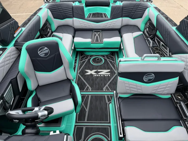 Slide: The Image of The interior of a 2025 Tigé Ultré 23ZX features luxurious seating in black, gray, and turquoise. - 19