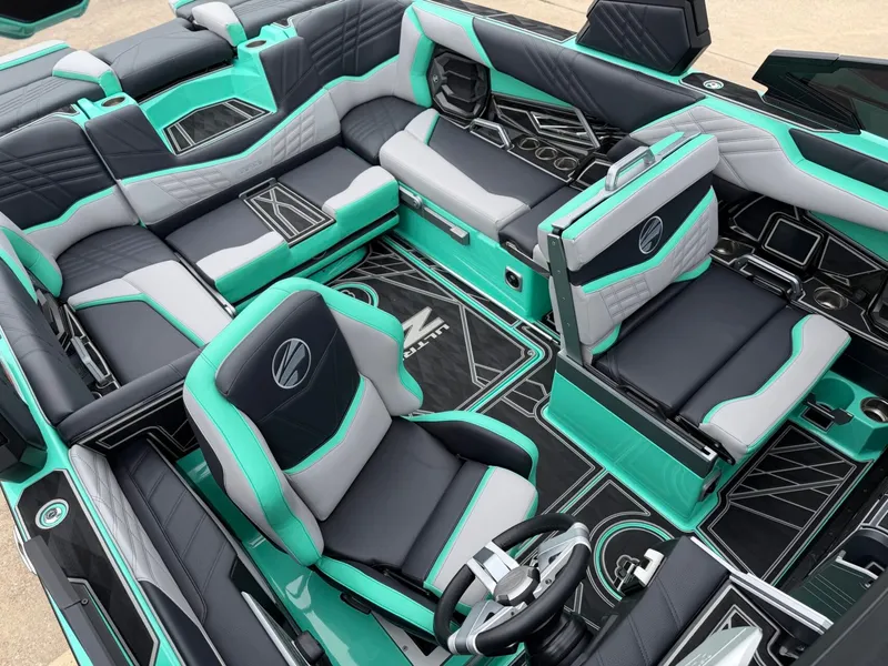 Slide: The Image of The interior of a 2025 Tigé Ultré 23ZX features luxurious turquoise and gray seating. - 21