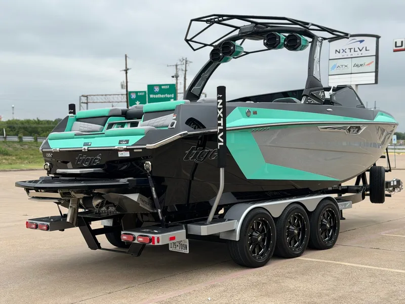 Slide: The Image of A 2025 Tigé Ultré 23ZX boat on a trailer, featuring a turquoise and gray hull. - 5