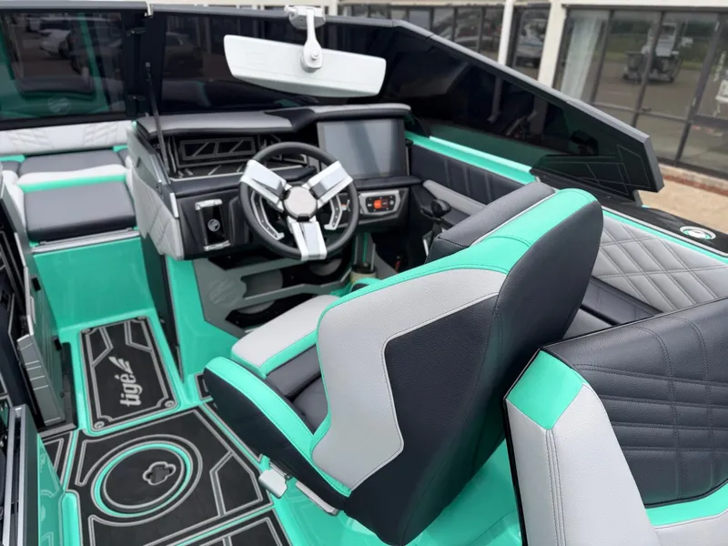 Slide: The Image of The image shows the cockpit of a 2025 Tigé Ultré 23ZX with modern seating and a stylish steering wheel. - 14