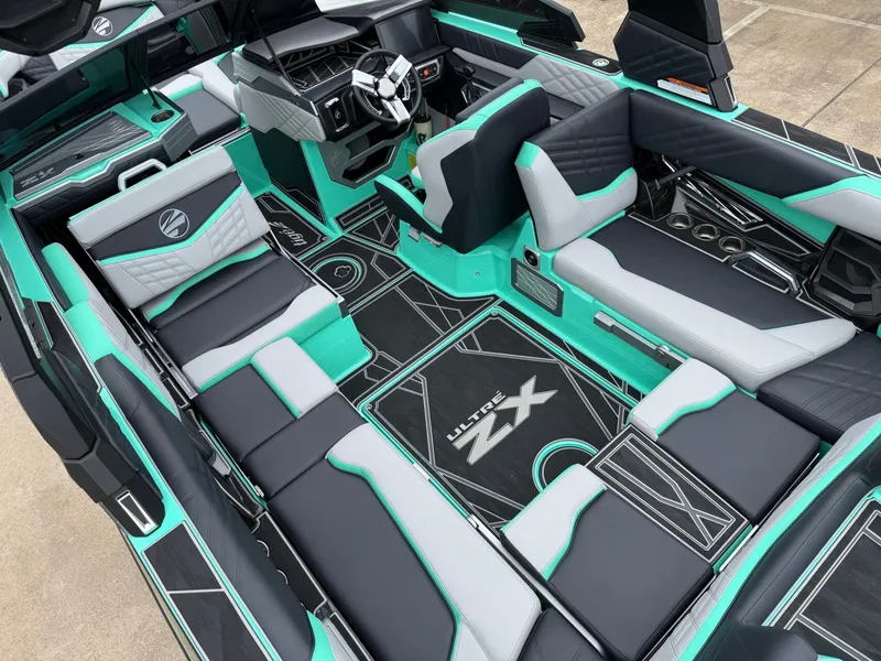 Slide: The Image of The interior of a 2025 Tigé Ultré 23ZX boat features stylish, modern seating and a sleek dashboard. - 10