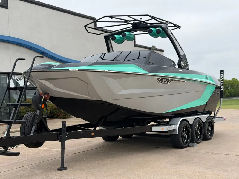 Slide: The Image of The image shows a modern motorboat on a trailer. It features a sleek design with turquoise accents. - 2