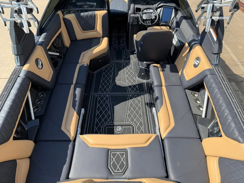Slide: The Image of The image shows the luxurious interior of a 2022 Tigé 25ZX boat with sleek seating. - 10