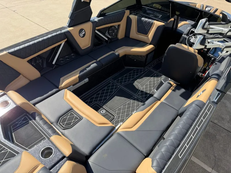 Slide: The Image of Interior of a 2022 Tigé 25ZX with luxurious black and brown upholstery and modern detailing. - 11