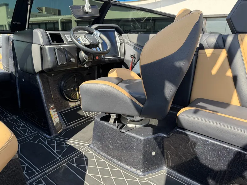 Slide: The Image of The image shows the cockpit of a 2022 Tigé 25ZX boat with modern seating and controls. - 16