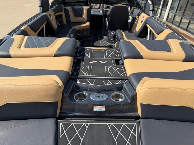 Slide: The Image of The image shows the interior of a 2022 Tigé 25ZX boat with luxurious seating and stylish design. - 8