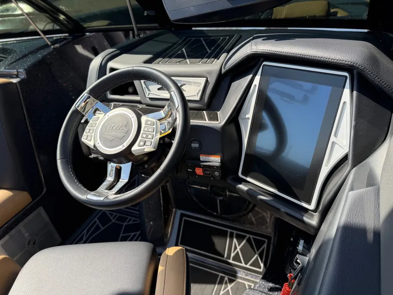 Slide: The Image of The image shows the cockpit of a 2022 Tigé 25ZX with a modern steering wheel and large display. - 17