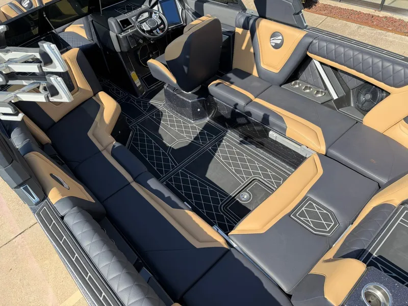Slide: The Image of The image shows the luxurious interior of a 2022 Tigé 25ZX boat with sleek seating. - 12