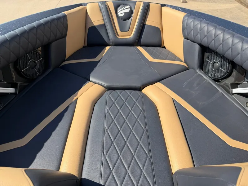 Slide: The Image of The image shows the luxurious bow area of a 2022 Tigé 25ZX boat with cushioned seating. - 18
