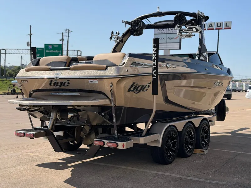 Slide: The Image of A 2022 Tigé 25ZX boat on a trailer, ready for transport. - 6