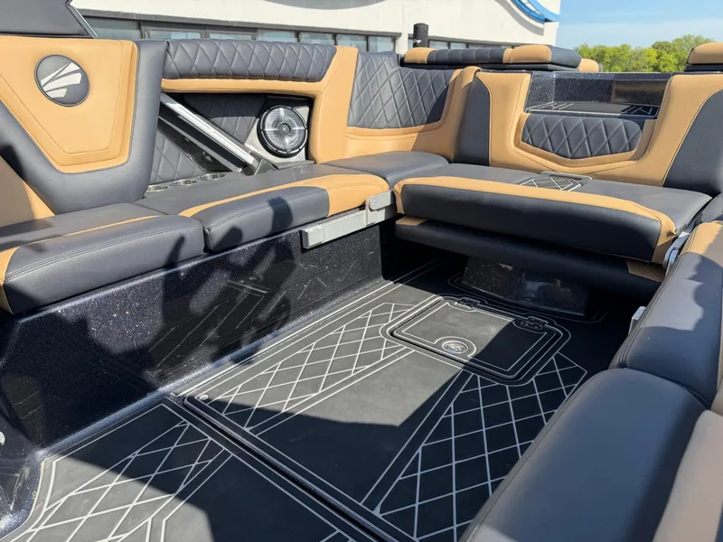 Slide: The Image of The image shows the luxurious interior of a 2022 Tigé 25ZX boat with sleek black and brown upholstery. - 15
