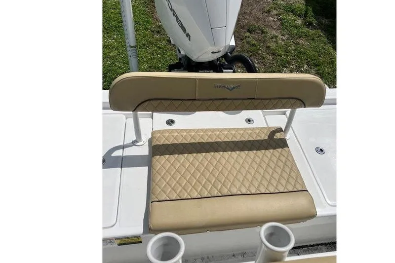 Slide: The Image of Beige quilted seat on 2025 Savannah 220 IS boat, with motor in background. - 6