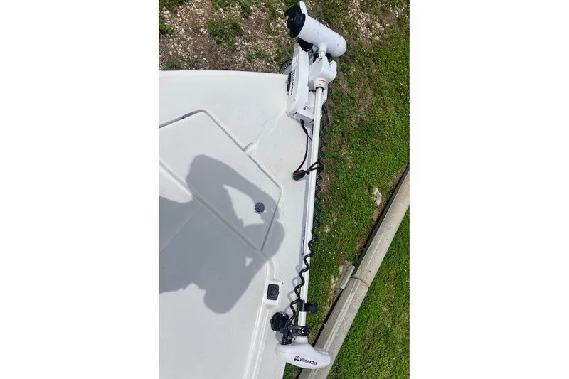 Slide: The Image of 2025 Savannah 220 IS boat deck with mounted trolling motor, shadow visible. - 9