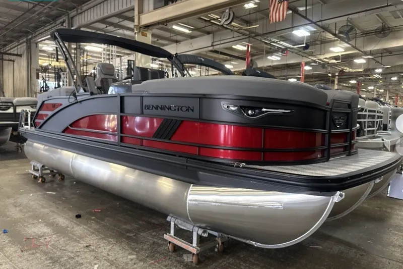 The Image of 2027 Bennington 22 M Open Fastback Quad Bench pontoon boat in a factory setting. - 0