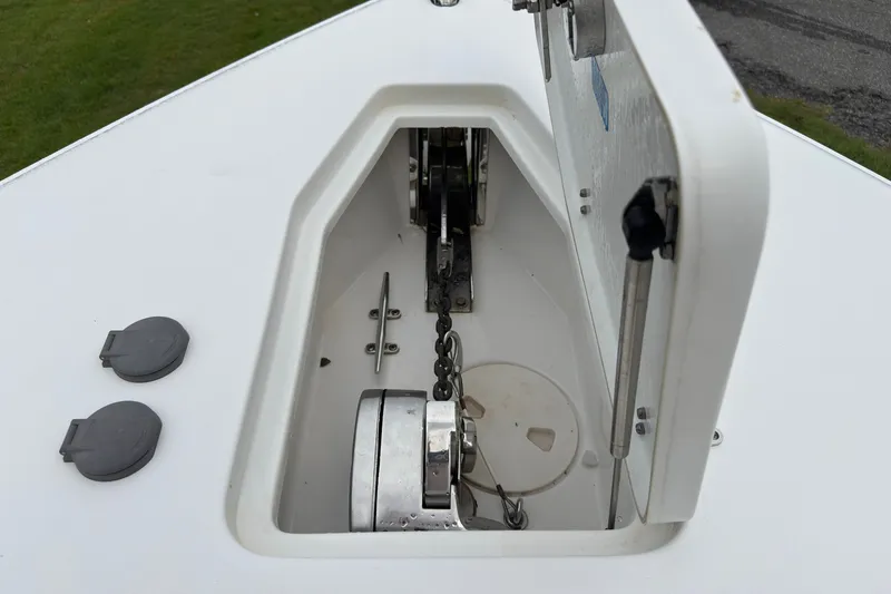 Slide: The Image of Anchor compartment of a 2019 Sea Hunt Gamefish 27 boat, showcasing chain and winch. - 35