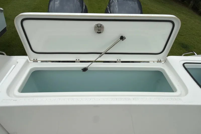 Slide: The Image of Open storage compartment on 2019 Sea Hunt Gamefish 27 boat, showcasing interior space. - 31