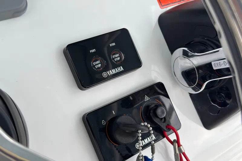 Slide: The Image of Control panel of a 2019 Sea Hunt Gamefish 27 boat with Yamaha start-stop buttons. - 25