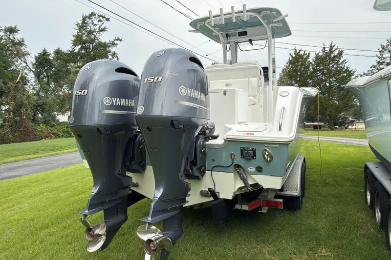 Slide: The Image of 2019 Sea Hunt Gamefish 27 with twin Yamaha 150 engines on grassy area. - 7